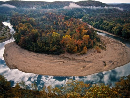 Aerial view of a river bend through Ozark hardwood forest